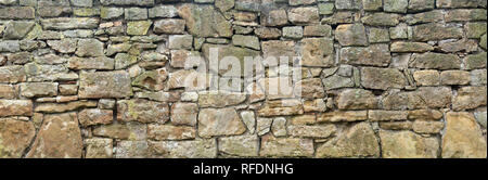 Rough, very old natural stone wall Stock Photo