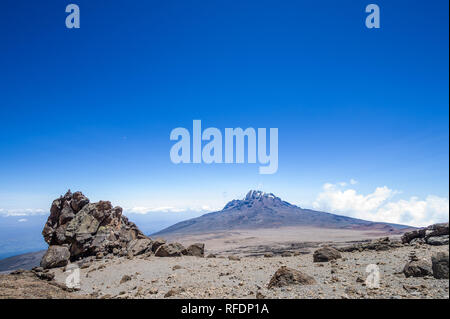 Visitors to Africa's tallest mountain and the world's tallest freestanding mountain, Mount Kilimanjaro, pass through 5 vegetation zones on the climb Stock Photo