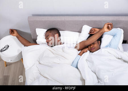 Young african american couple napping in bed together Stock Photo ...