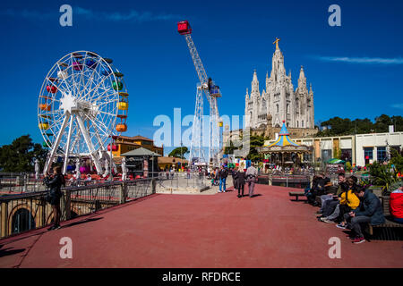 Amusement park in front of Temple Expiatori del Sagrat Cor, Temple of the Sacred Heart of Jesus in Tibidabo Stock Photo