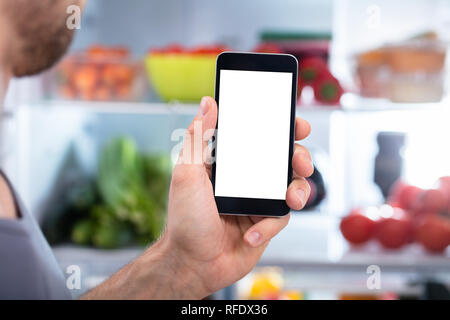 Close-up Of A Person's Hand Holding Mobilephone With Blank Screen Stock Photo