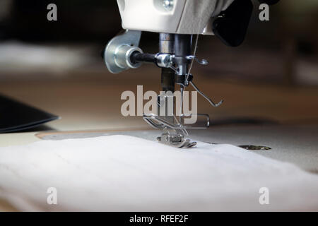 Close up of modern sewing machine and item of clothing, old sewing machine, vintage style Stock Photo