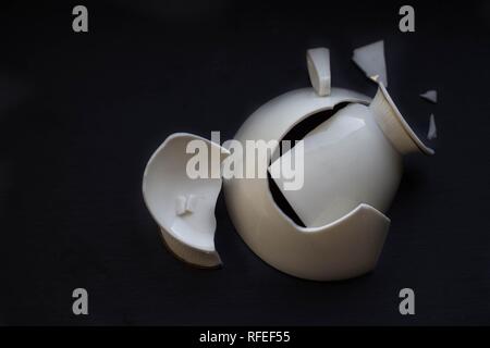 broken white china cup on black background Stock Photo