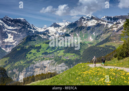Switzerland, Alps, Berner Oberland, Spring. Grindelwald, Kleine Scheidegg. View of Weisse Lutschine valley. Hikers, senior couple. Stock Photo
