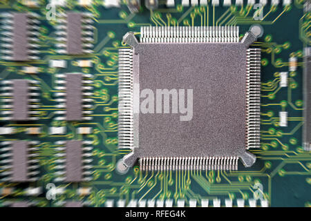 PCB Printed Circuit Board with many electrical components Stock Photo