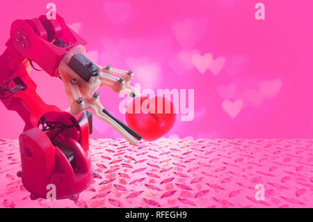 industry robotic arm Holding Red Heart , Close-up Of A Robot's Hand Holding Red Heart Stock Photo