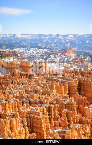 View of the amphitheatre in the morning light, snow-covered bizarre rocky landscape with Hoodoos in winter, Rim Trail Stock Photo