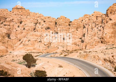 Kings highway, beautiful curvy road running through the Wadi Rum desert with rocky mountains in the distance in Jordan. Stock Photo