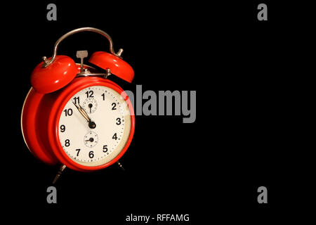 Red alarm clock on black background Stock Photo