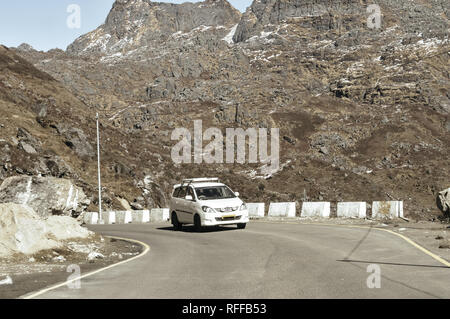 Car traveling downhill on curved mountain roads. Vehicle driving driving in a hairpin bend shoot from car. Rural Roadside. Road trip travel concept