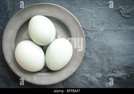 Eggs, eggshells on pewter plate Stock Photo