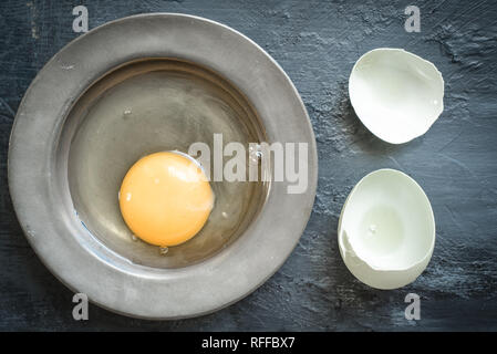 Eggs, eggshells on pewter plate Stock Photo