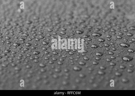 Water droplets on reflective surface Stock Photo