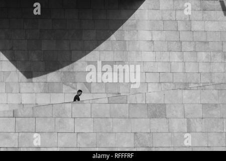A man climbs the stairs of the Guggenheim Museum in Bilbao in black and white, Spain Stock Photo