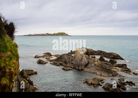 Coast of the Vizcaya village of Mundaca on a beautiful cloudy day, Spain Stock Photo