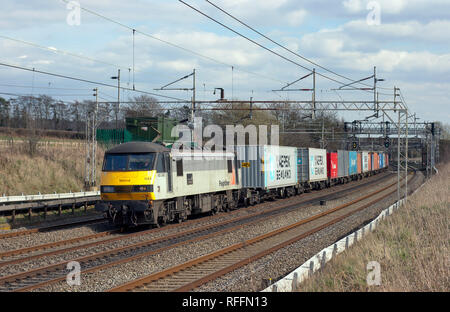 A class 90 electric locomotive number 90043 working a Freightliner at Dudswell on the West Coast Mainline. Stock Photo