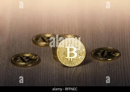 Bitcoin gold coins on a wooden table Stock Photo