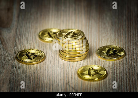 Bitcoin gold coins on a wooden table Stock Photo