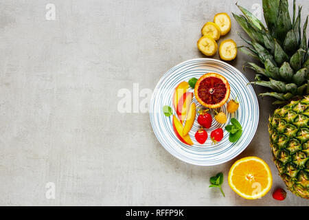 Tropical fruits and fresh berries flat lay. Food concept. Top view Stock Photo
