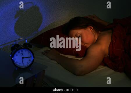 Young woman is sleeping in her bed Stock Photo