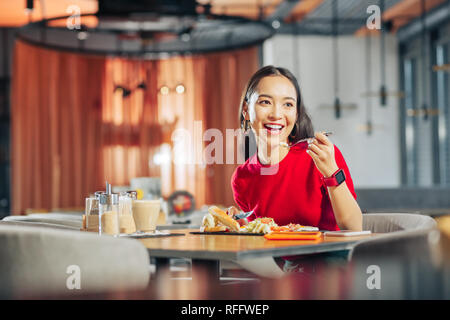 Dark-eyed woman feeling rested enjoying weekend breakfast Stock Photo
