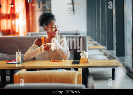 Beautiful girlfriend drinking coffee while waiting for her man Stock Photo