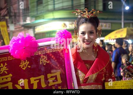 Unidentified Chinese pretty fairy lady hold a signboard on street in parade during Chinese New Year festival in Nakorn Sawan Province , Thailand. Stock Photo