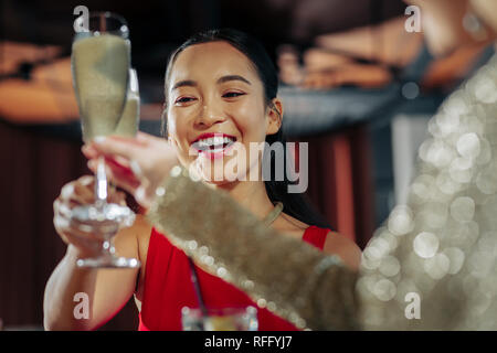 Woman smiling broadly while celebrating birthday with friends Stock Photo