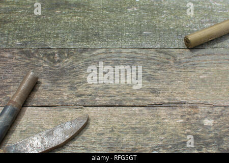 Weathered pallet wood boards as a background with rusty steel stock placed in the lower left corner and brass stock placed in the upper right corner. Stock Photo