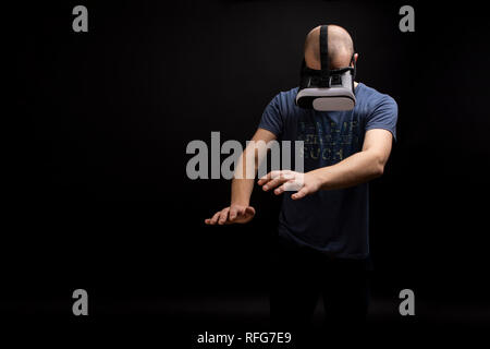 Male enjoying a 3D experience using a VR gadget. Gaming indoors activity fun for adults and children. Copy space available Stock Photo