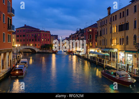 Night view of the canal, bridge, and old buildings in Venice, Italy Stock Photo