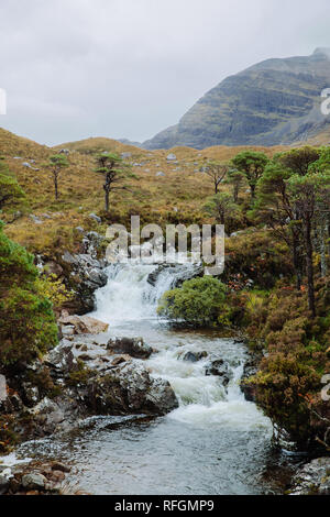 A view of the Allt Coire Rooill river and surrounding countryside near Torridon, Scotland Stock Photo