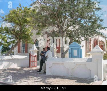 March 27, 2005 - Grand Turk Island, Turks & Caicos - Two Grand Turk Island men talk at the entrance to church on Grand Turk Island, the capital island of the Turks and Caicos archipelago in the Atlantic Ocean and a frequent cruise ship port of call. Credit: Arnold Drapkin/ZUMA Wire/Alamy Live News