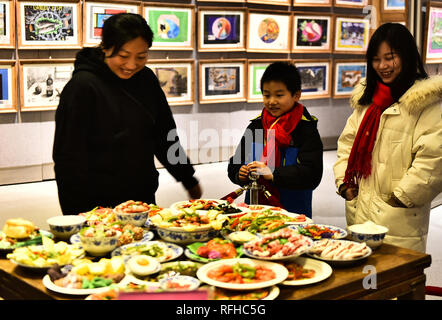 Hefei, China's Anhui Province. 25th Jan, 2019. Visitors view the Spring Festival dishes made of polymer clay during an exhibition at Laishaoqi Gallery in Hefei, capital of east China's Anhui Province, Jan. 25, 2019. The Spring Festival, or the Chinese Lunar New Year which falls on Feb. 5 this year, is the most important festival in China. On New Year's Eve, the biggest event is the annual family reunion dinner. Credit: Ge Yinian/Xinhua/Alamy Live News Stock Photo