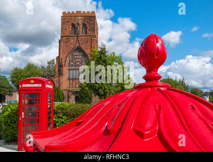 Shrewsbury Abbey with a red phone box and Penfold pillar box, Shropshire, England, UK Stock Photo