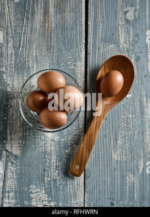 eggs in the glass bowl on the wooden table - closeup Stock Photo