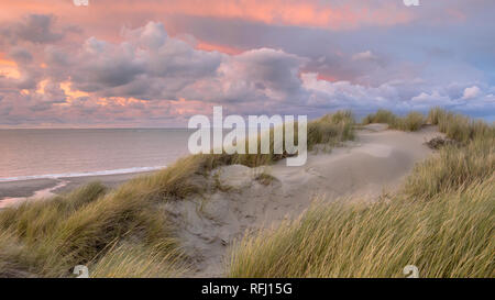 Sunset View from dune on North Sea and Canal in Zeeland, Netherlands Stock Photo