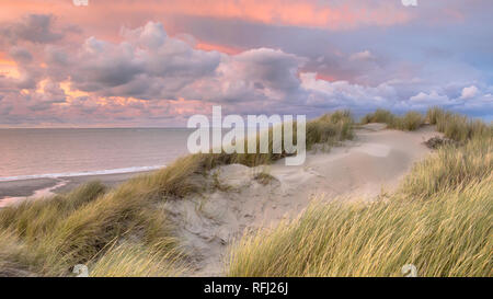Sunset View from dune on North Sea and Canal in Zeeland, Netherlands Stock Photo