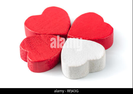 Three red and one white wooden hearts isolated on white Stock Photo