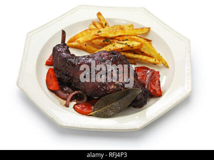 rabbit cooked in red wine with french fries Stock Photo