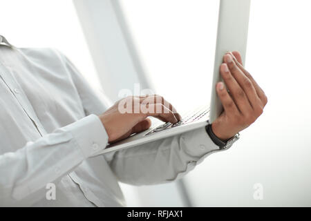 close up. image of a businessman holding an open laptop Stock Photo