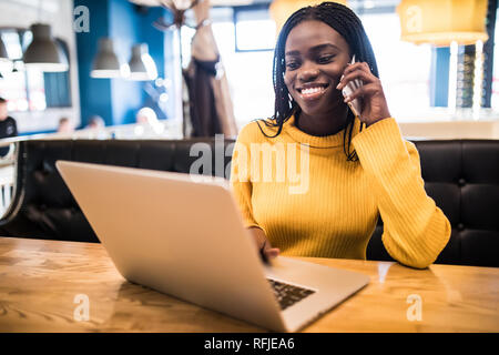 Professional African american copywriter talking about new project on mobile earning money online. Stock Photo