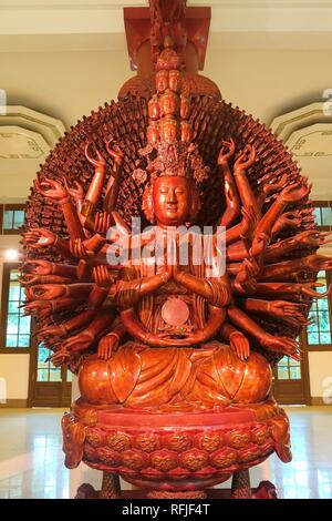 Avalokitesvara (Kuan Yin) with many eyes and arms, sculptor Truong, But Thap pagoda, Bac Ninh province, Restored Le, 1656 AD, crimson & gilded wood - Stock Photo