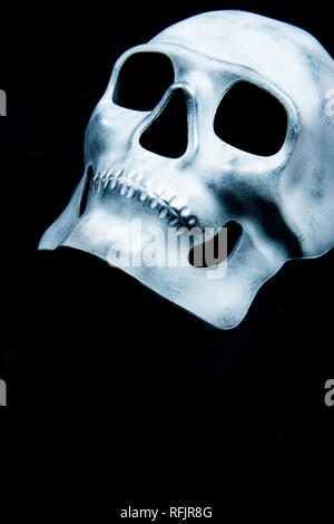 White skull mask on a black background Stock Photo