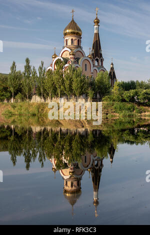 Russian orthodox Church of Exaltation of the Holy Cross with reflections, Almaty, Kazakhstan Stock Photo