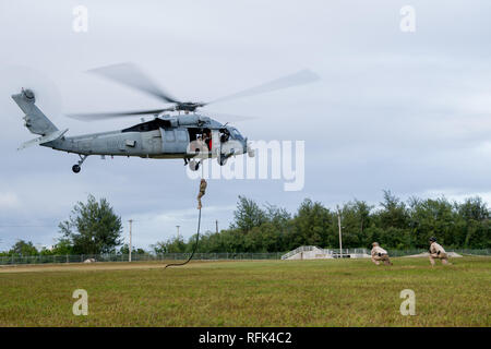 190122-N-VR594-1234  SANTA RITA, Guam (Jan. 22, 2019) Sailors assigned to Explosive Ordnance Disposal Mobile Unit (EODMU) 5 conduct fast rope training from an MH-60S Sea Hawk helicopter from the 'Island Knights' of Helicopter Sea Combat Squadron 25. EODMU-5 is assigned to Commander, Task Force 75, the primary expeditionary task force responsible for the planning and execution of coastal riverine operations, explosive ordnance disposal, diving engineering and construction, and underwater construction in the U.S. 7th Fleet area of operations. (U.S. Navy photo by Mass Communication Specialist 2nd Stock Photo