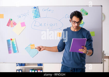 Young handsome designer working at the project Stock Photo