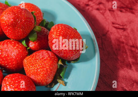 valentines red strawberries in teal blue dish with melted bitter