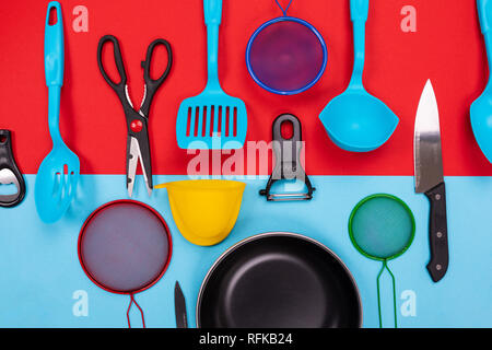 Kitchen utensils isolated on red-blue background Stock Photo