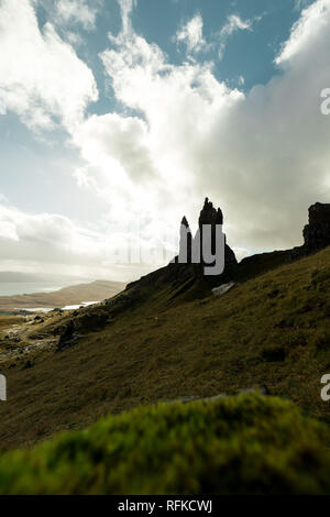 Old Man of Storr as seen from a higher viewpoint with dramatic sky and bright sun (Isle of Skye, Scotland, United Kingdom) Stock Photo